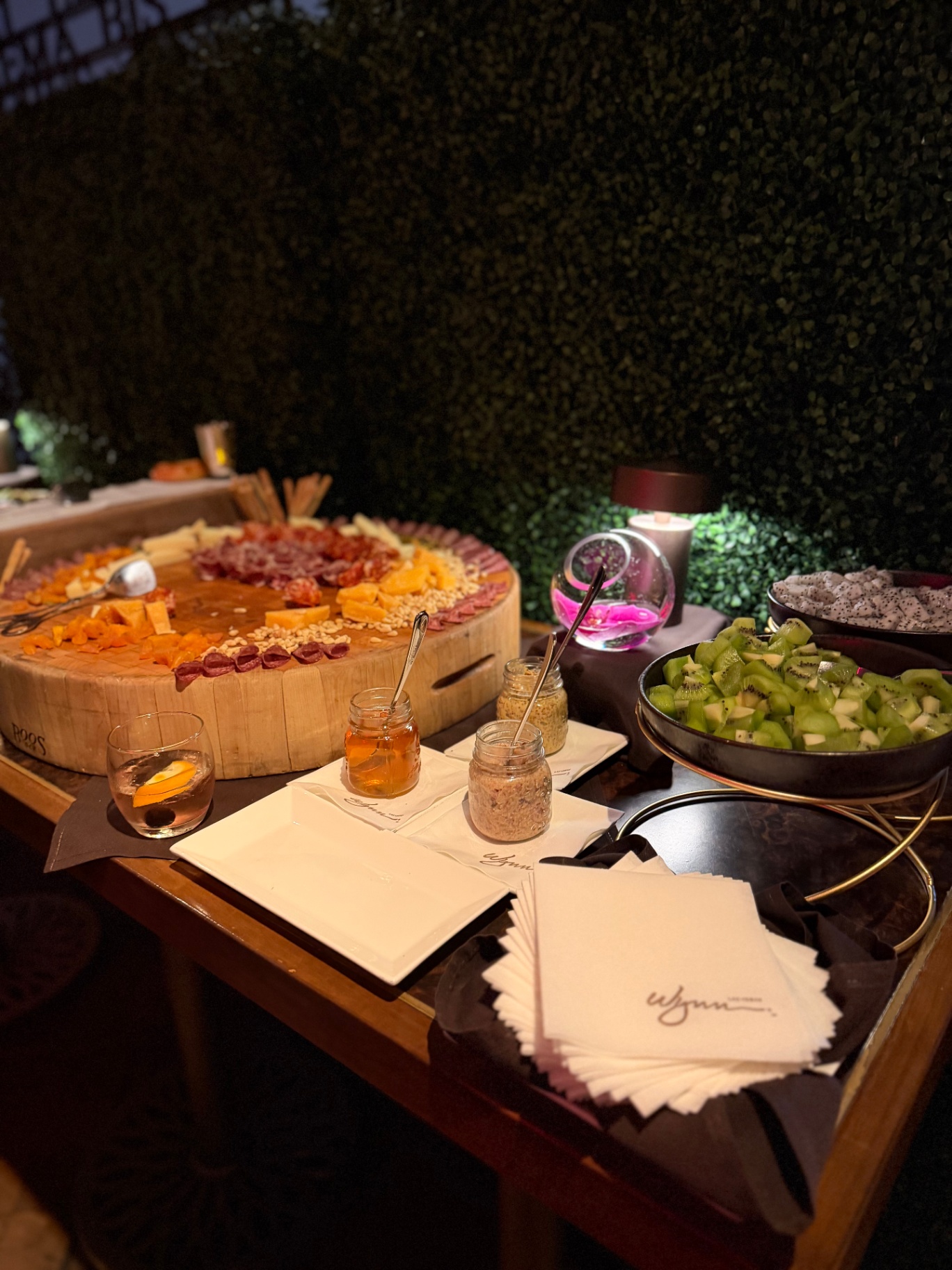 A partner-hosted spread of charcuterie, fruit, and cocktails at the Wynn
