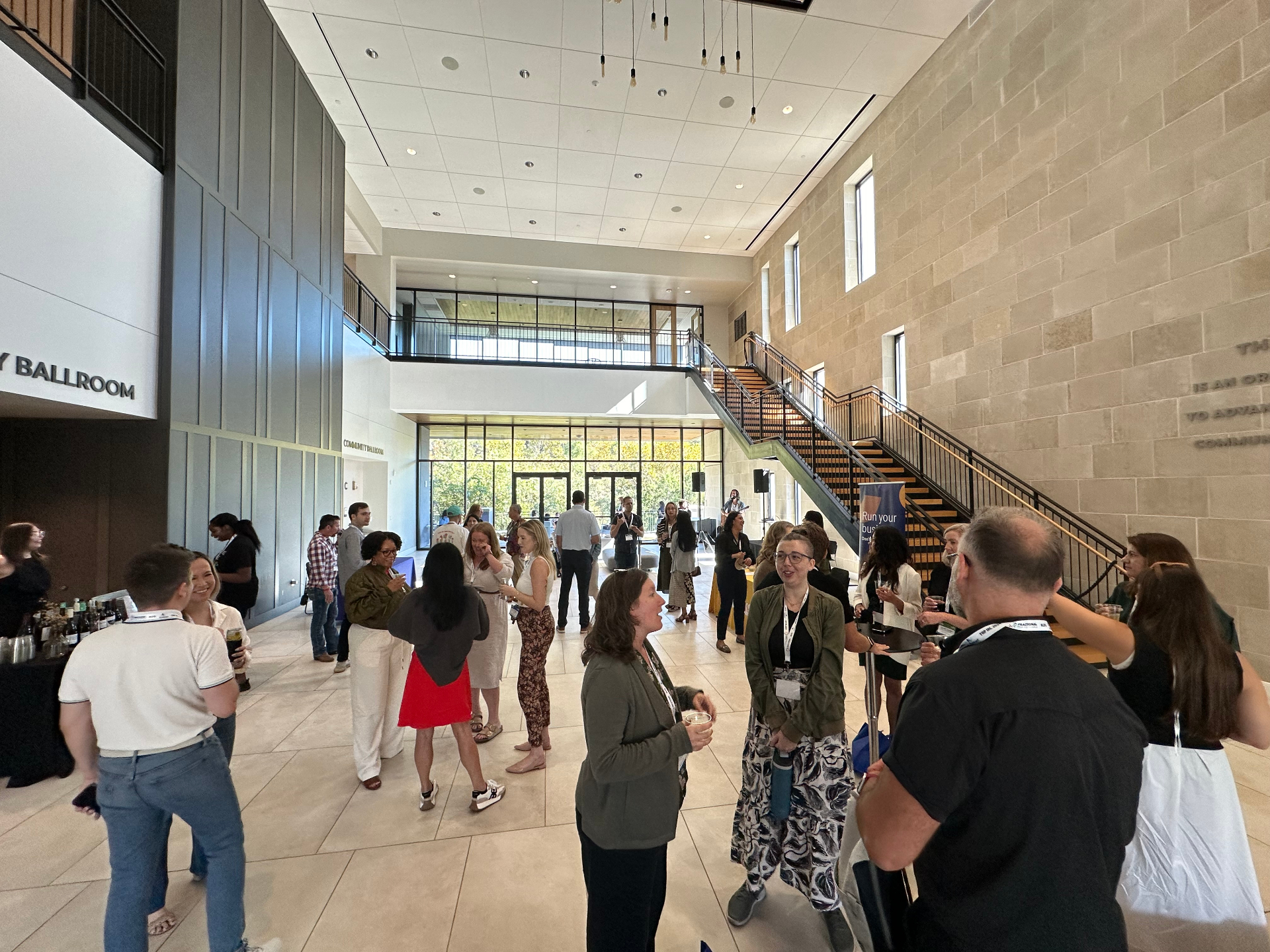 FPP members mingling in a bright lobby before programming begins
