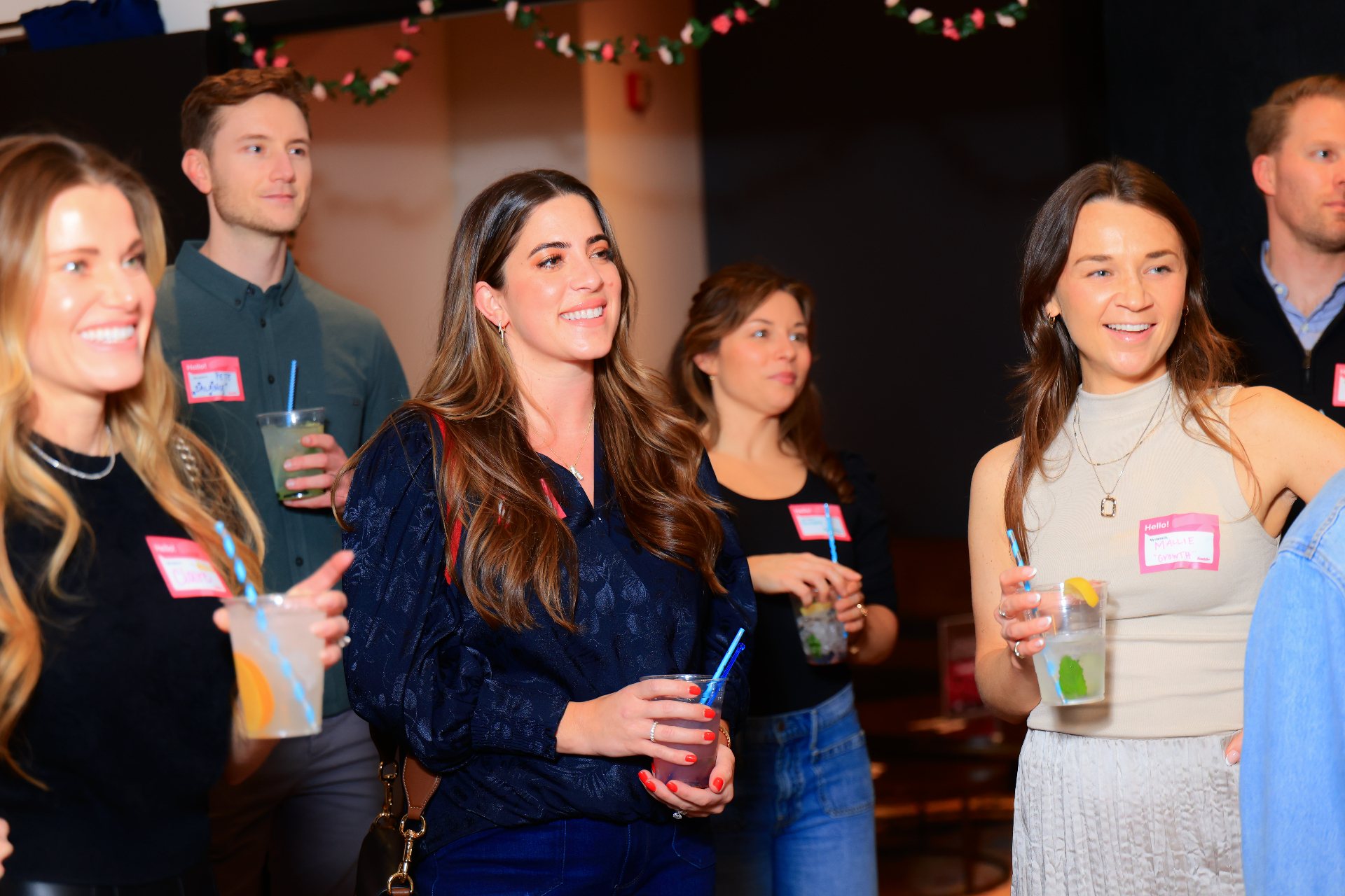 Manifest and Mingle attendees chatting with drinks in hand